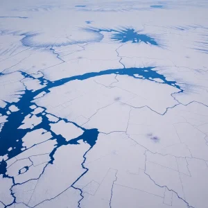 Aerial view of Greenland showcasing its icy terrain and natural resources.